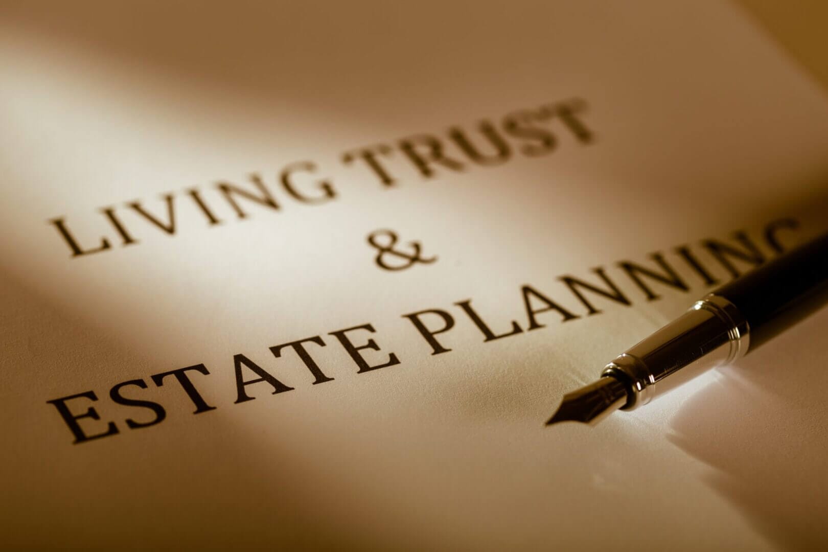 Close-up view of a trusts and estate planning document, featuring formal legal text, signatures, and annotations on a paper set against a neutral, professional background.